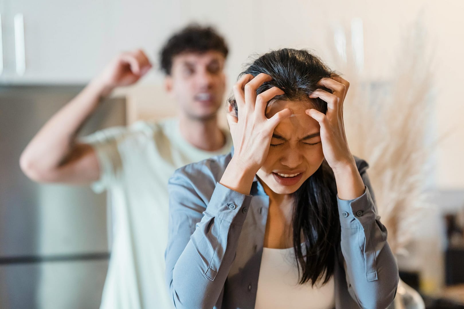 pexels-photo-8560432-8560432 An upset couple arguing in a kitchen, highlighting stress and frustration in relationships.