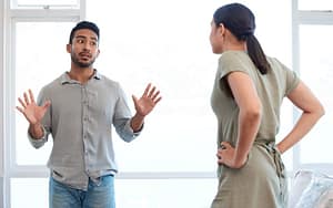 Two people are conversing with visible tension.