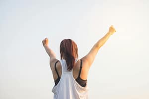 Woman celebrating A woman celebrates success with arms raised