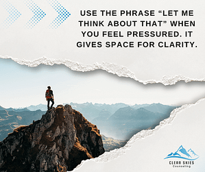 A person stands on a mountain peak, overlooking vast landscapes.