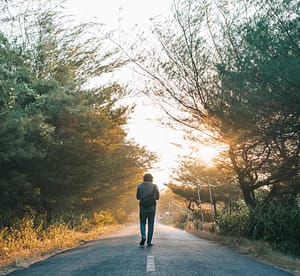 Man walking alone A man walks alone on road to addiction recovery